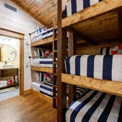 Bunk beds beside the bunk room's bathroom door