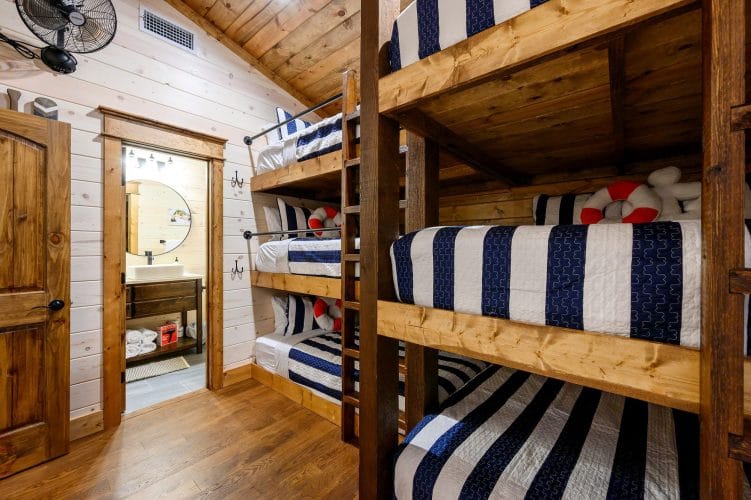 Bunk beds beside the bunk room's bathroom door