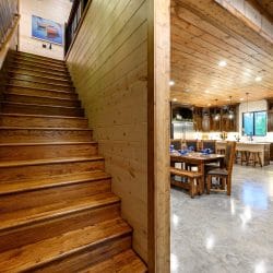 Wood staircase with the dining area behind it