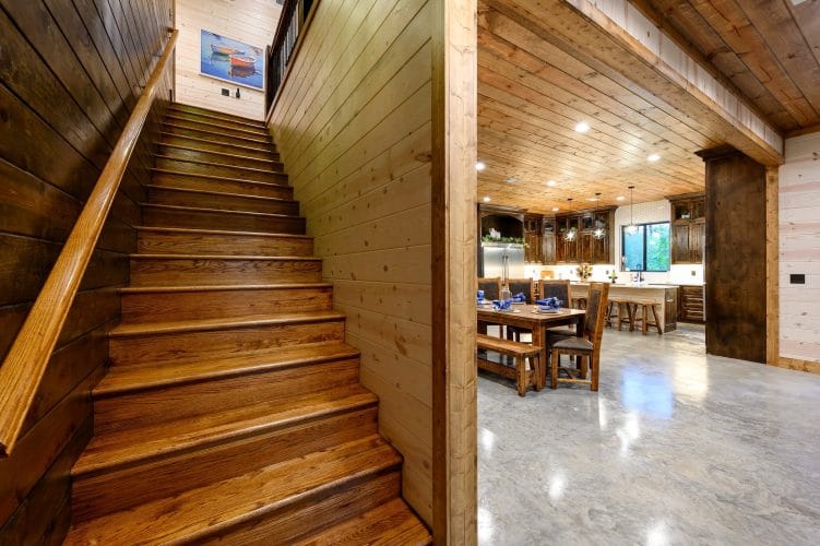 Wood staircase with the dining area behind it