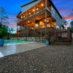 Multi-level decks above the pool, lit at dusk