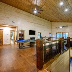 Upstairs game room overlooking the living room, with a pool table and shuffleboard