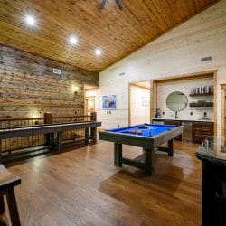 Shuffleboard, a blue-felt pool table and the bar nook in the loft
