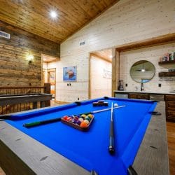 Blue-felt pool table with balls racked