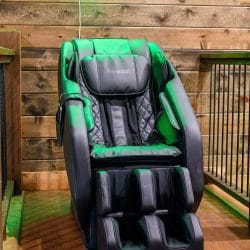Black and green massage chair next to the loft railing