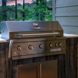Built-in stainless grill on a rustic wood base