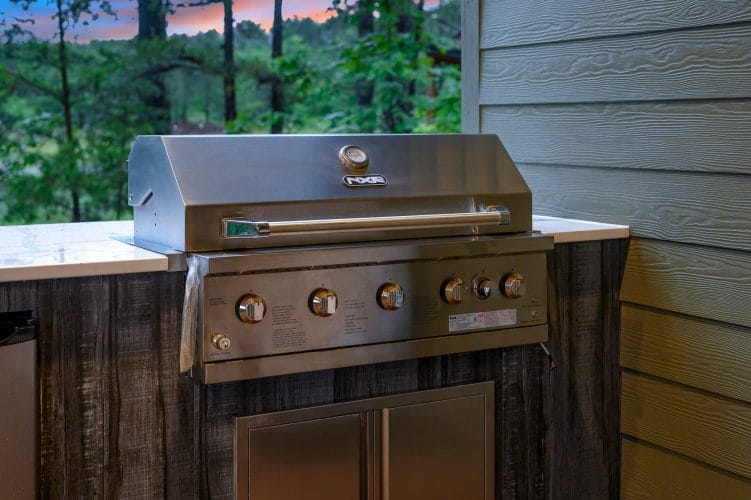 Built-in stainless grill on a rustic wood base