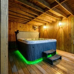 Hot tub with green underlighting on the lower deck