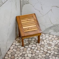 Wood shower bench inside a tiled shower