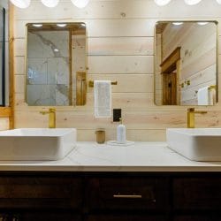 Two vessel sinks and mirrors over a dark wood vanity