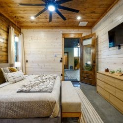 Same king bedroom showing the TV, dresser and door to the covered patio