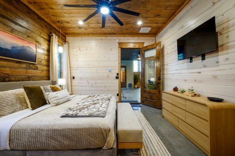 Same king bedroom showing the TV, dresser and door to the covered patio