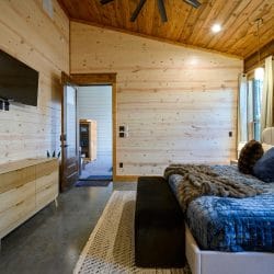 King bedroom showing the TV, dresser and bathroom door