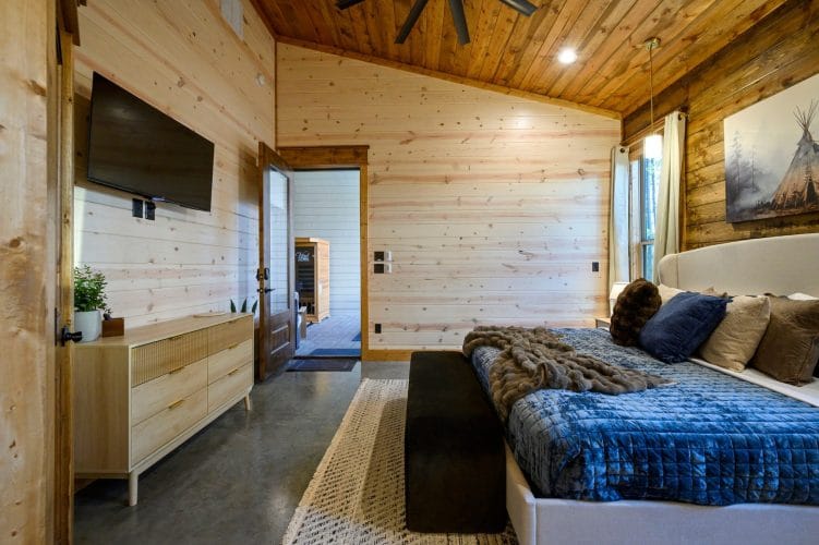 King bedroom showing the TV, dresser and bathroom door