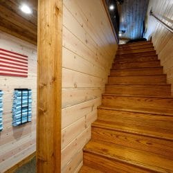 Wood staircase with an American flag sign on the wall