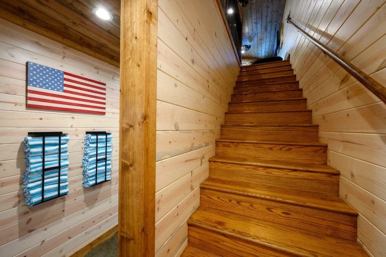 Wood staircase with an American flag sign on the wall