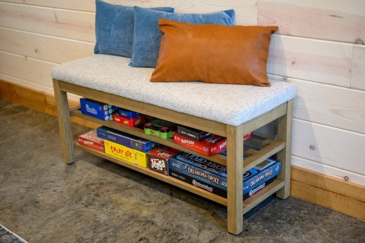 Bench with board games stored on a shelf underneath
