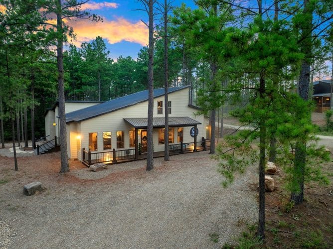 House seen through pines from the drive