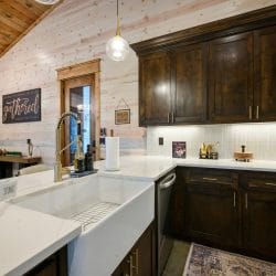 Farmhouse sink and dark wood cabinets in the kitchen