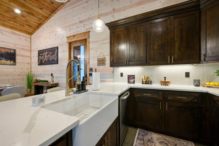 Farmhouse sink and dark wood cabinets in the kitchen