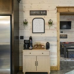 Coffee bar cart with a sign above it, game room visible through the doorway
