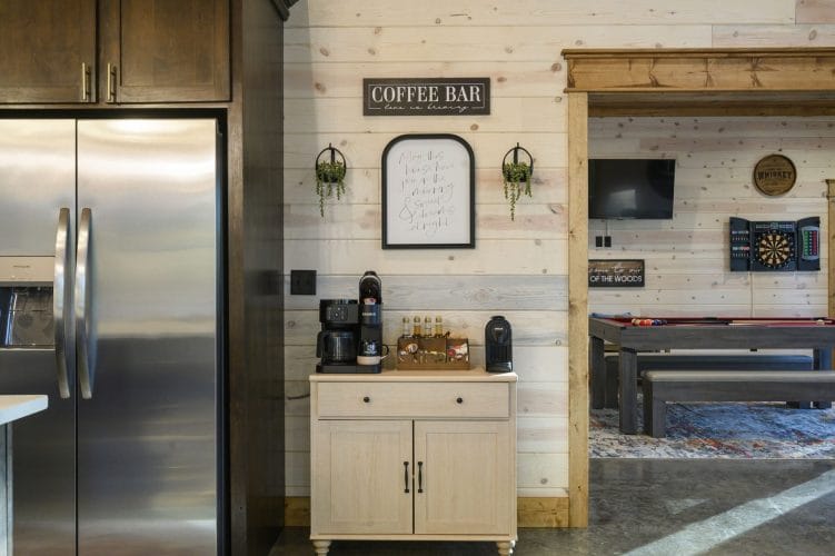 Coffee bar cart with a sign above it, game room visible through the doorway