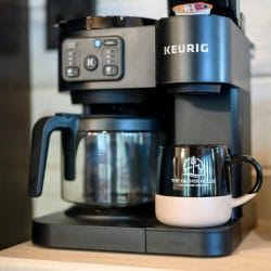 Keurig coffee maker with a mug on the coffee bar