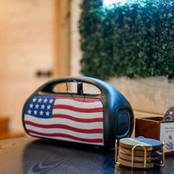 Flag-print portable speaker on a side table