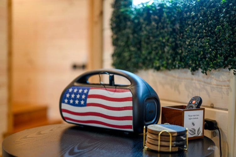 Flag-print portable speaker on a side table