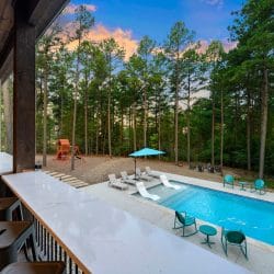 View over the patio bar counter to the pool and playset