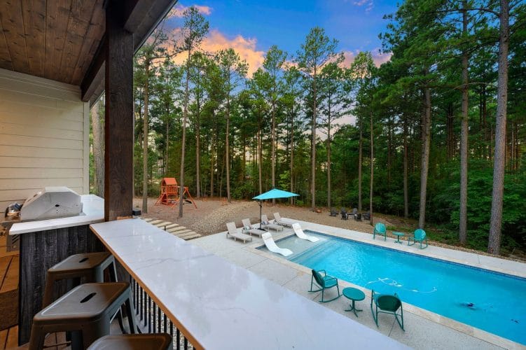 View over the patio bar counter to the pool and playset