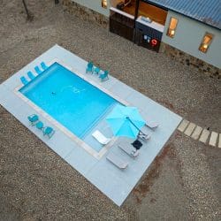 Aerial of the pool with loungers and an umbrella