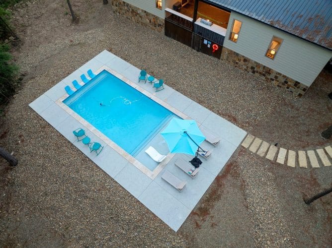 Aerial of the pool with loungers and an umbrella
