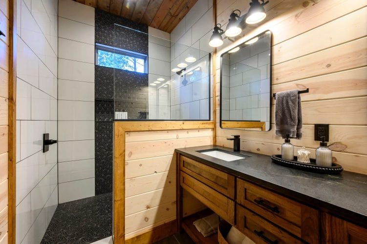 Bathroom sink beside a window into the shower