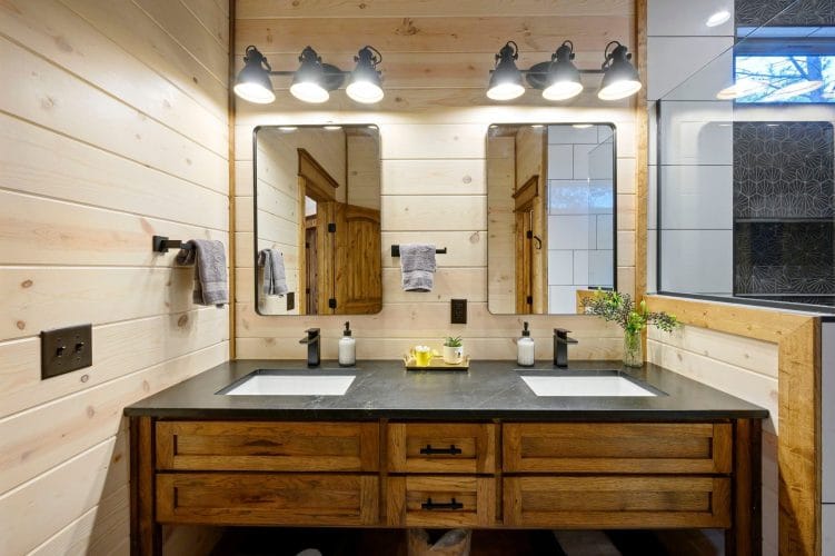 Bathroom sink with a rustic wood-framed mirror and wood door