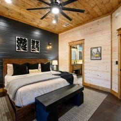 Same bedroom showing the bed and the open doorway to the private bathroom