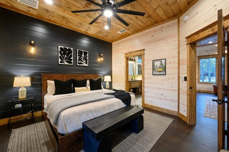 Same bedroom showing the bed and the open doorway to the private bathroom