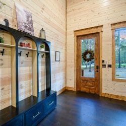 Entry hall with a wood-framed glass door, wall hooks and a framed sign