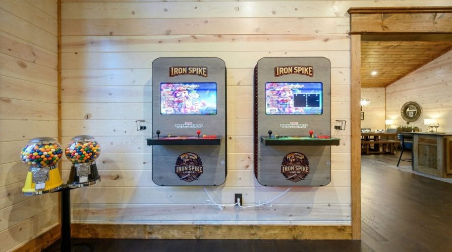 Two Iron Spike Lodge arcade machines with joysticks and game screens