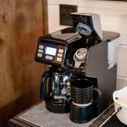 Close view of a coffee maker with a pod in the brew chamber