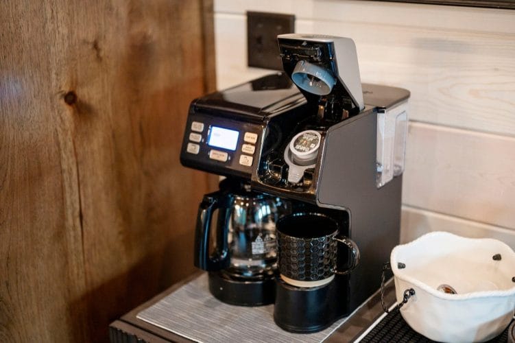 Close view of a coffee maker with a pod in the brew chamber