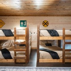 Close view of a wood bunk bed in the loft with quilted bedding