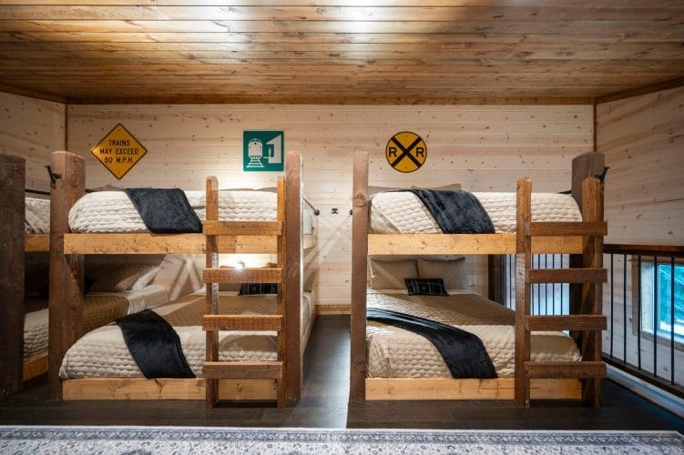 Close view of a wood bunk bed in the loft with quilted bedding