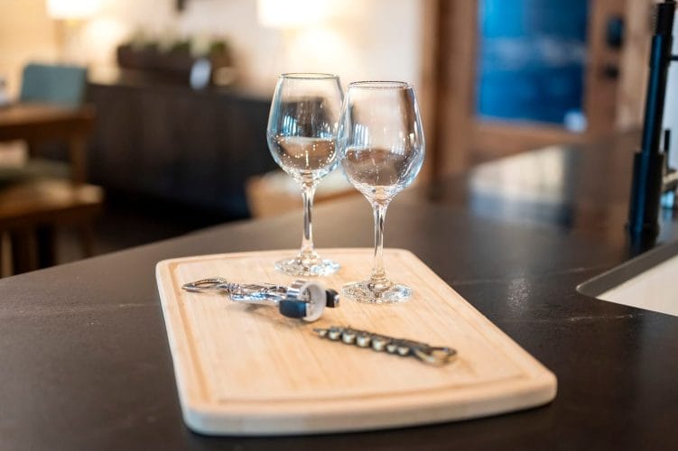 Two wine glasses on a wood board