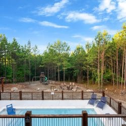 Playset and picnic table at the edge of the woods
