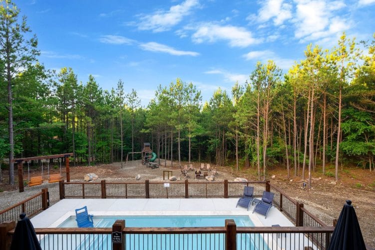 Playset and picnic table at the edge of the woods