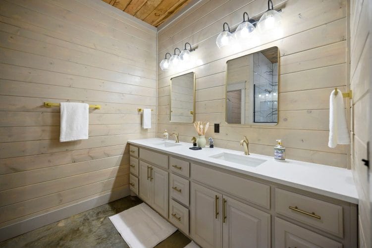 Double vanity with brass fixtures and two mirrors