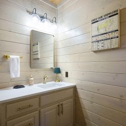 Vanity with a mirror and a framed poster on the wall