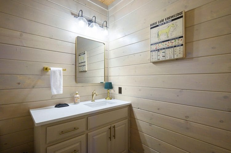 Vanity with a mirror and a framed poster on the wall