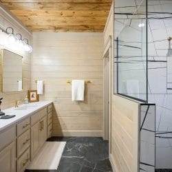 Vanity next to a walk-in shower with a tile floor